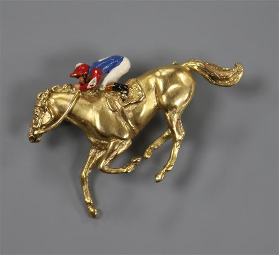 A 9ct gold and enamel horse and jockey brooch (a.f.), 37mm.